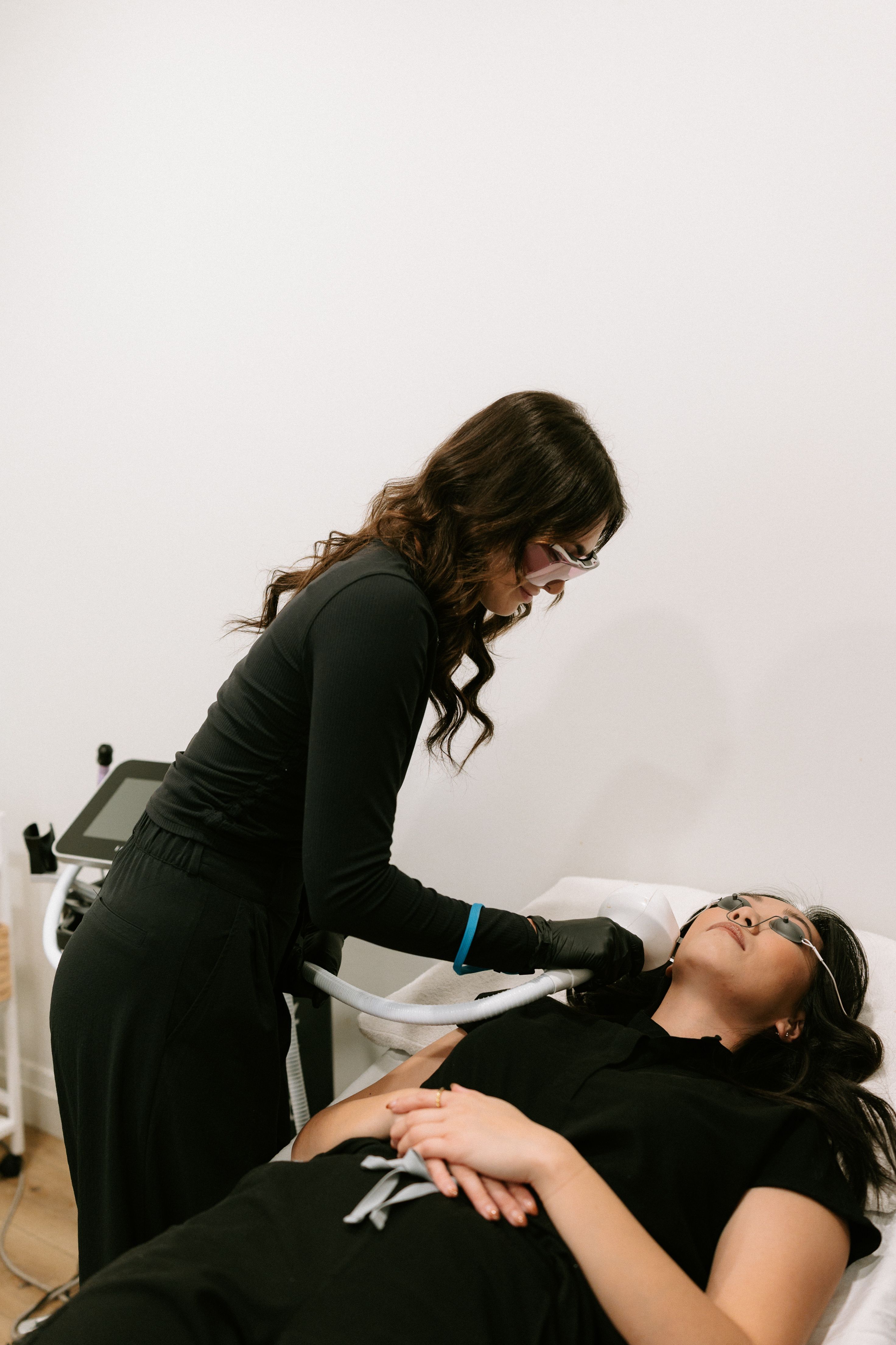 Laser treatment with clinician and client in safety goggles